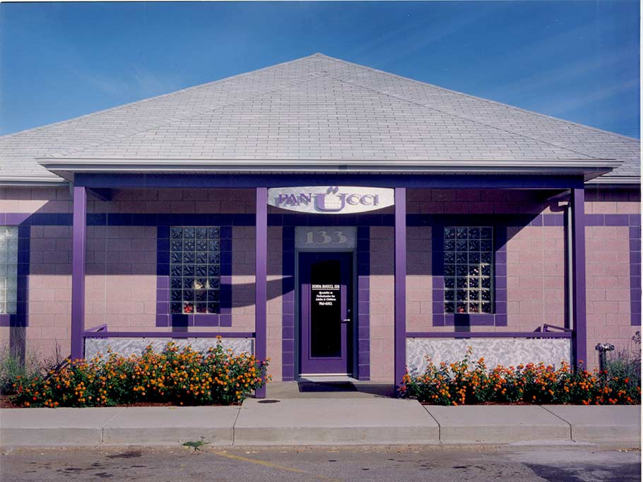 Orthodontist, Donna Panucci bought a lot in a mixed use (commercial and residential) neighborhood in South Charleston, WV. We designed her office to fit in with the scale of the residential but the commercial qualities that would offer her a long lasting, low maintenance building. Her company color is purple as you might guess and the exterior materials are ground face block and glazed block in purples. The sign and railing are hand ground and textured aluminum.