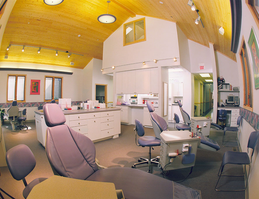 Being a nationally renown orthodontist, Dr. Panucci knew what she wanted in her new office and we enjoyed the experience of helping give her the new spaces. Here, an open operatory is given a warm wooden ceiling and several lighting sources to make an interesting distraction for your eye while in the chair. The Doctor's office looks down from above and is skylit.